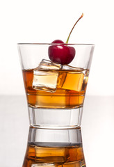Glass with whiskey splash on white background