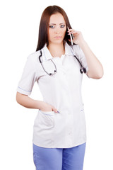 Young woman medical doctor talking on mobile phone.