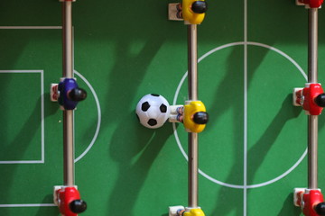 football - board game with players, soccer ball and green field