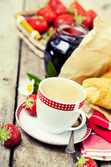 Cup of coffee, croissants and strawberries, toned