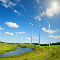 Wind generators turbines on summer landscape
