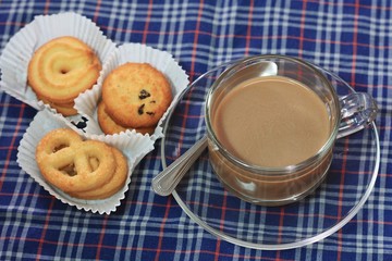 Cup of coffee and cookies on chintz Scots.