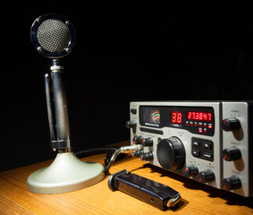Classic two-way radio with red channel and frequency display, old school microphone and...