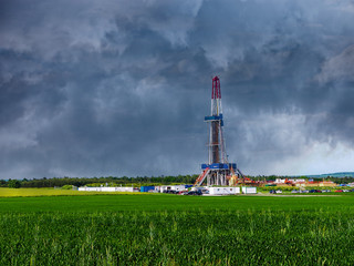 Natural gas drilling worksite with dramatic sky.