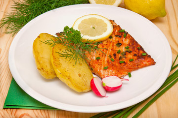 Grilled salmon fillet with boiled potatoes,lemon. 