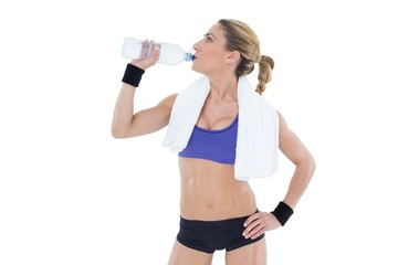 Strong blonde drinking from water bottle