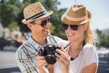 Hip young couple looking at their camera