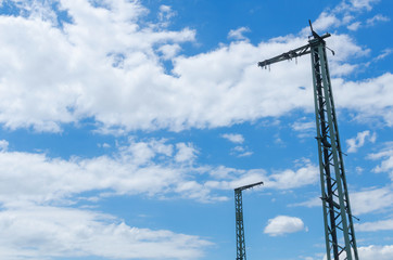 Obraz premium two old railway masts in front of a dramatic cloudy sky