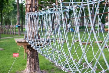 The bridge of logs tied to the ropes, part of a ropes course