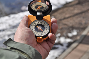 The compass in his hand.