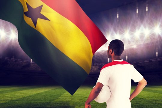 Composite image of football fan in white holding ball