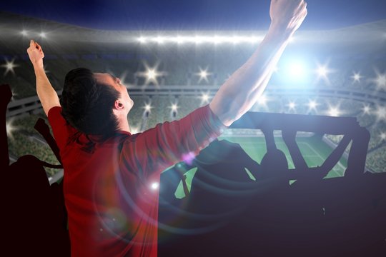Composite image of cheering football fan in red jersey