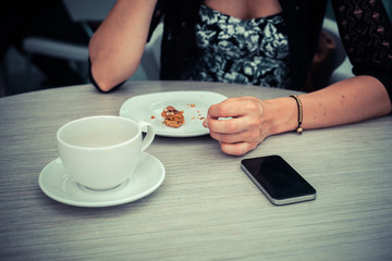 Woman having coffee waiting for phone call