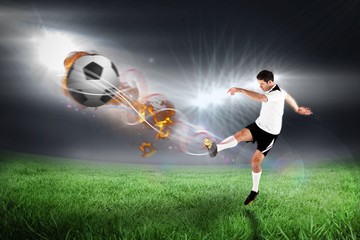 Obraz na płótnie Canvas Composite image of football player in white kicking