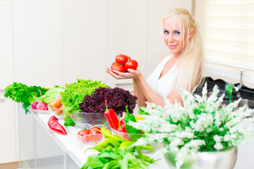 Happy woman cooks in the kitchen