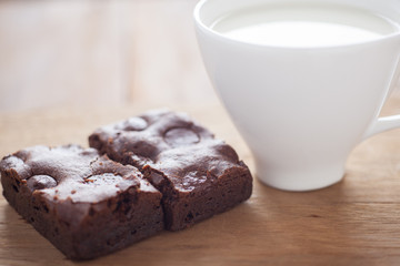 chocolate brownies dessert on wood, serve with hot milk