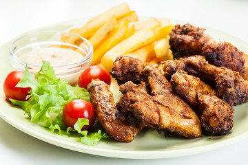 Chicken wings with fries french and spicy sauce