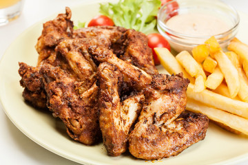 Chicken wings with fries french and spicy sauce