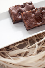 chocolate brownies dessert on the white plate and straw