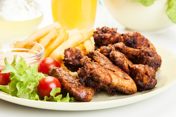 Chicken wings with fries french and spicy sauce