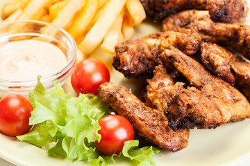 Chicken wings with fries french and spicy sauce