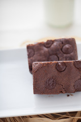 chocolate brownies dessert on the white plate and straw