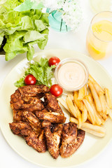 Chicken wings with fries french and spicy sauce