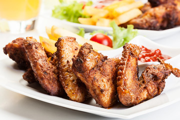 Chicken wings with fries french and spicy sauce