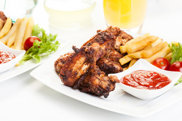 Chicken wings with fries french and spicy sauce