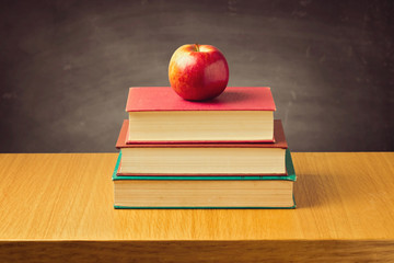 Apple on old vintage books. Back to school concept