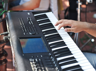 Obraz premium closeup shot of male hands playing the piano .Human hand playing