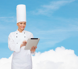 smiling female chef with tablet pc computer