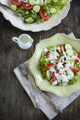 Fresh vegetable salad with feta cheese and tzatziki sauce