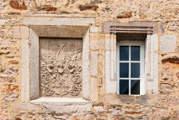 Fototapeta na wymiar Old stone building with window and ornamentation.