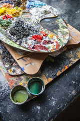 Palettes used to paint covered with oil colors very bright