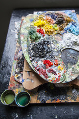 Palettes used to paint covered with oil colors very bright