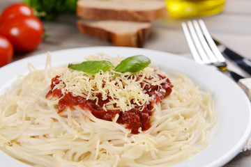 Pasta with tomato sauce on plate on table close-up