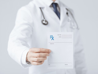 male doctor holding rx paper in hand - obrazy, fototapety, plakaty
