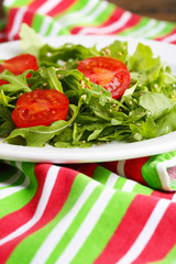 Green salad made with  arugula, tomatoes and sesame
