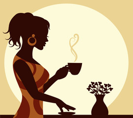 woman with a cup of steaming coffee in hand