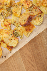 Homemade potato chips on wooden table