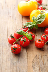 Fresh cherry tomatoes on old wooden table