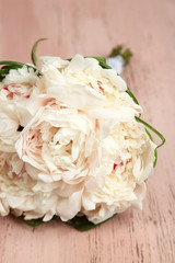Beautiful wedding bouquet on  color wooden background