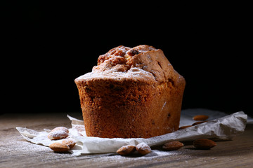 Tasty cake on table on black background