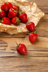 Red ripe strawberries with chocolate on wooden table