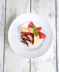 Tasty homemade strudel with ice-cream, fresh strawberry and