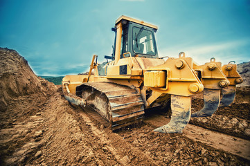 close-up of bulldozer or excavator working with soil on highway