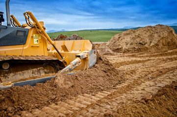 Heavy bulldozer and excavator loading  and moving red sand © aboutmomentsimages