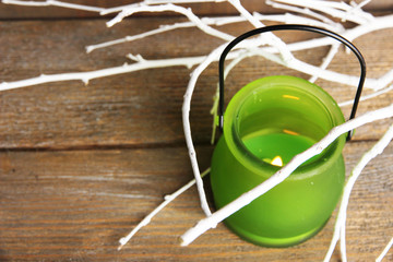 Bright icon-lamp with branches on wooden background