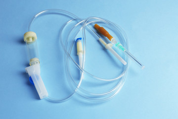 Disposable infusion set on blue background